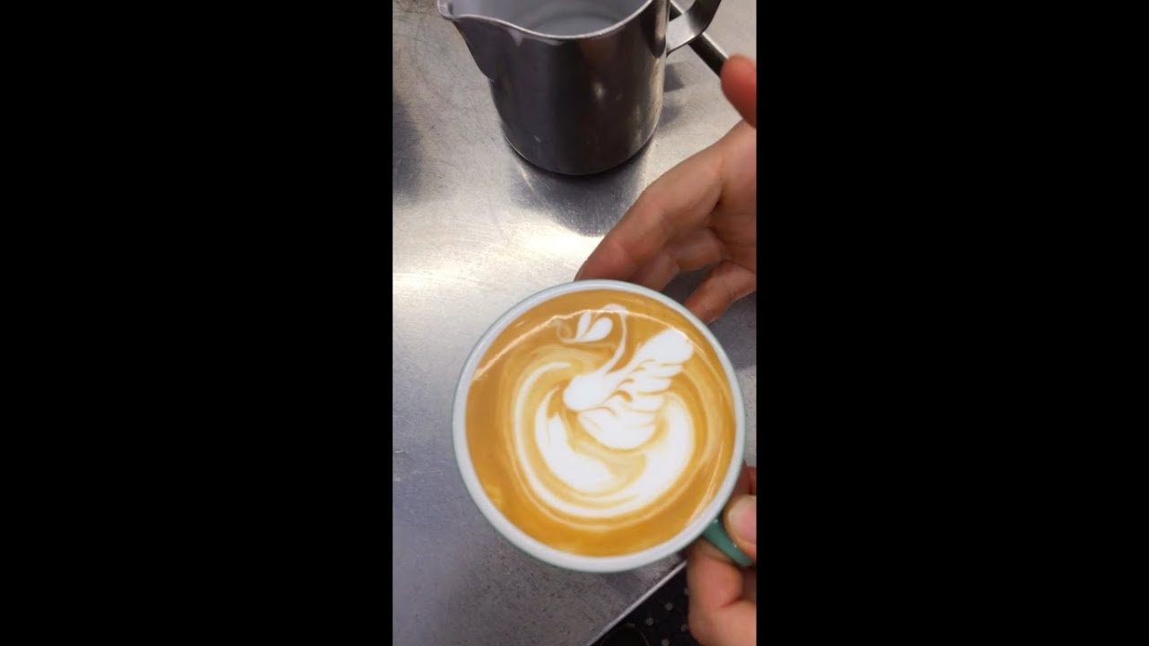 Swan latte art in a cup for a flat white coffee